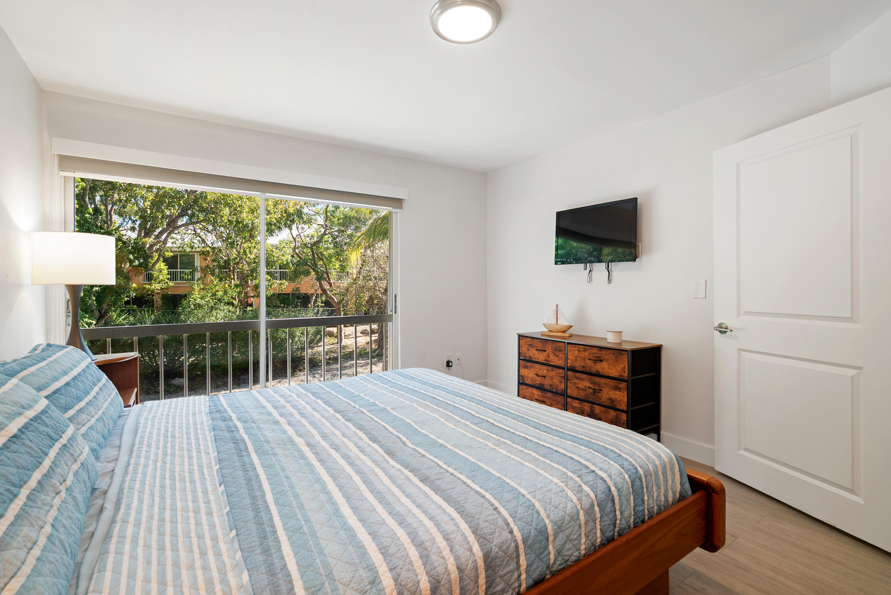 9871 Leeward Avenue Key Largo, FL 33037 - Photo 10 of 38 a bedroom with a bed and a flat screen tv