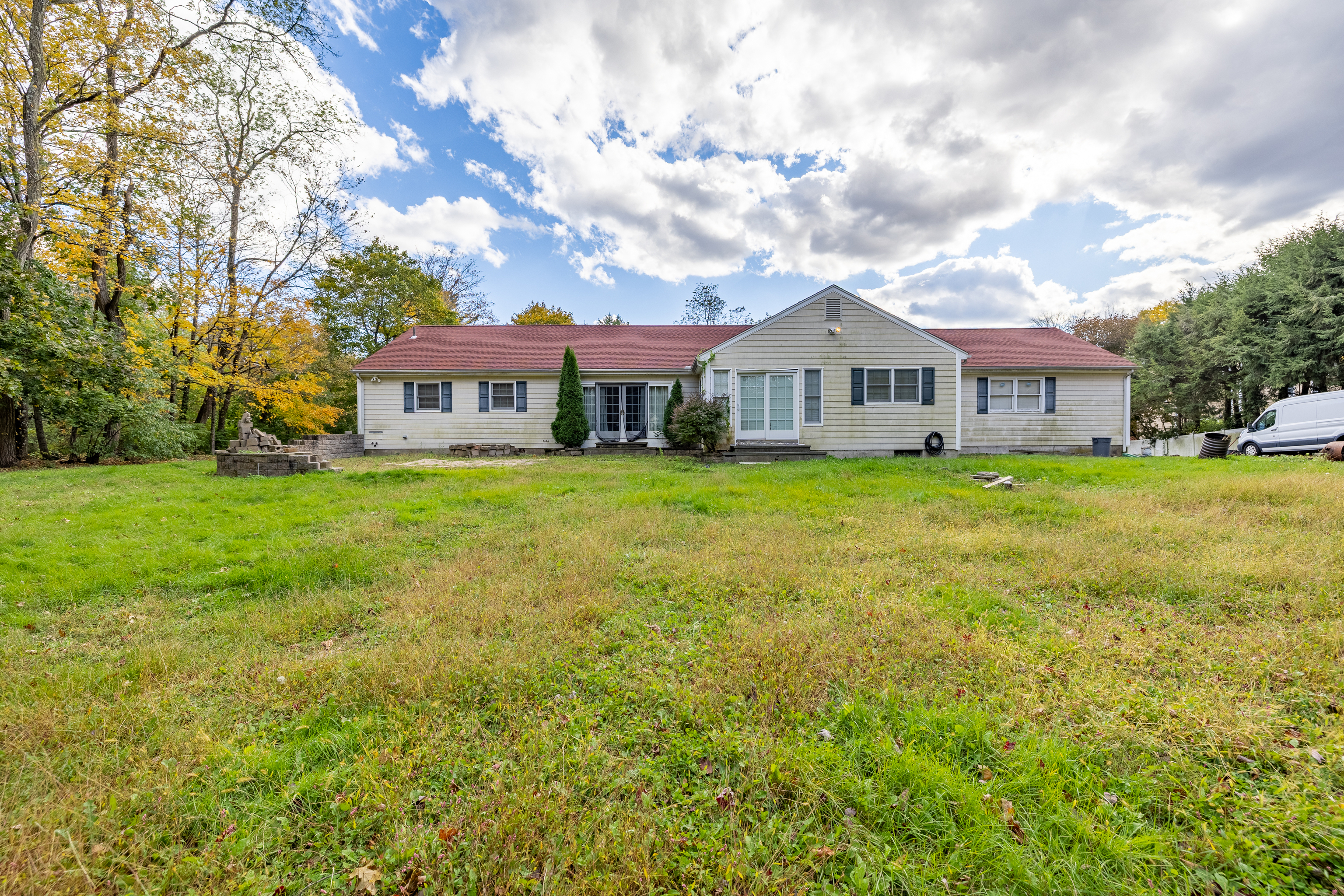 78 Trinity Pass Stamford, CT 06903 - Photo 17 of 20 a view of a house next to a big yard and large trees