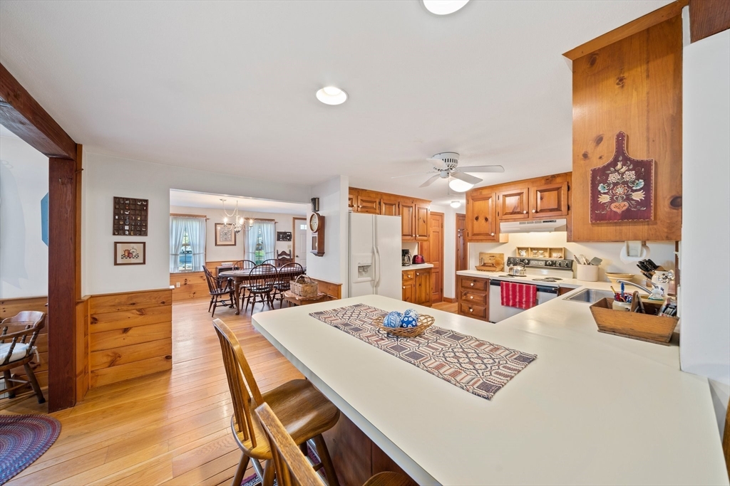 95 Wapping Road Kingston, MA 02364 - Photo 16 of 42 a view of a dining room with furniture a kitchen and chandelier