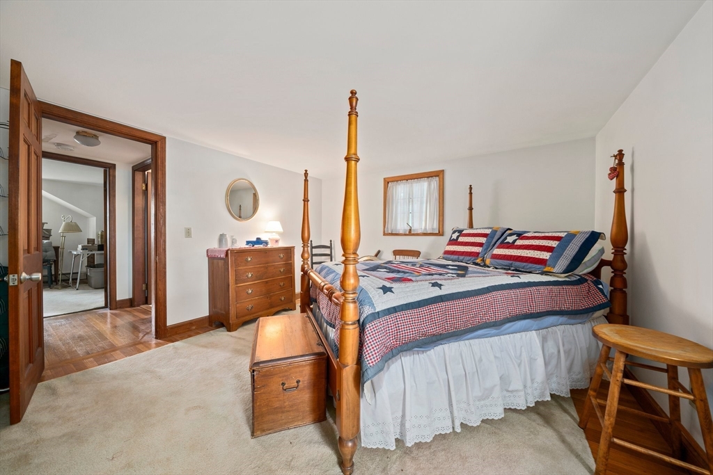 95 Wapping Road Kingston, MA 02364 - Photo 23 of 42 a bed room with a bed and a mirror