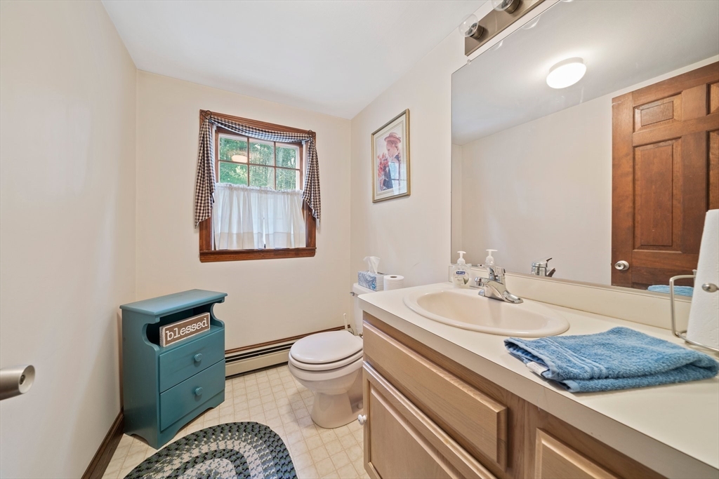 95 Wapping Road Kingston, MA 02364 - Photo 27 of 42 a bathroom with a granite countertop toilet sink and mirror