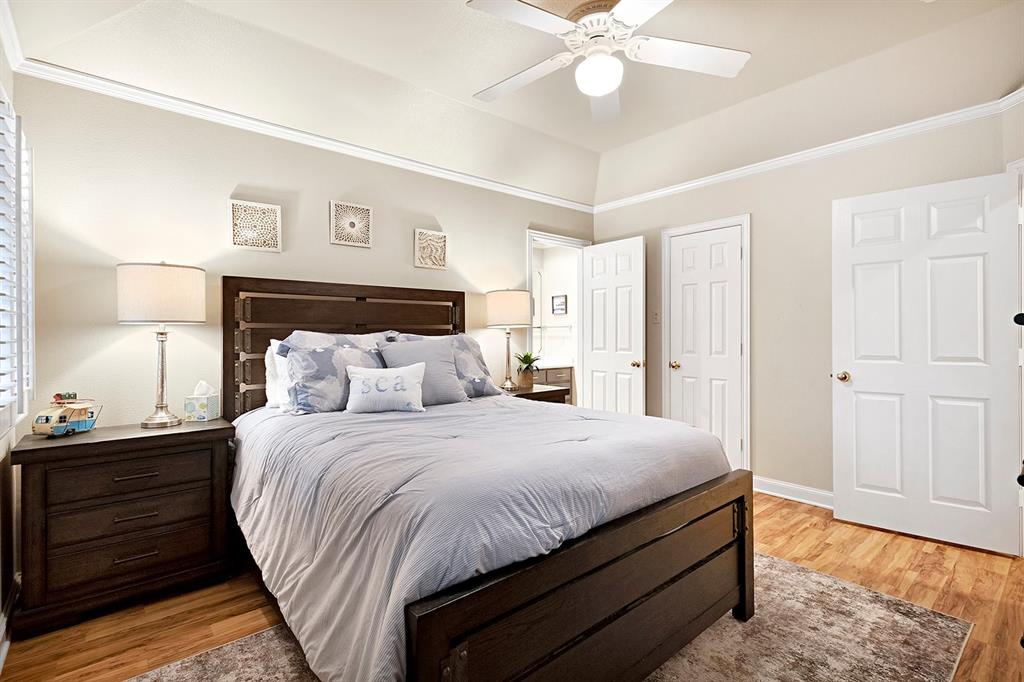 103 Glenn Road Mabank, TX 75156 - Photo 26 of 38 a bedroom with bed and wooden floor
