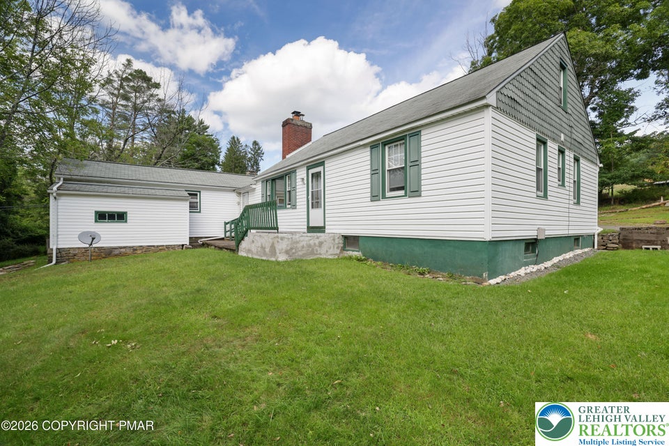 1207 Seese Hill Road Canadensis, PA 18325 - Photo 31 of 49 Crisp white siding and contrast shutters highlight this classic home bordered by a lush lawn.