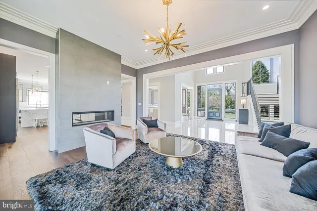 a kitchen with stainless steel appliances a dining table chairs refrigerator and microwave