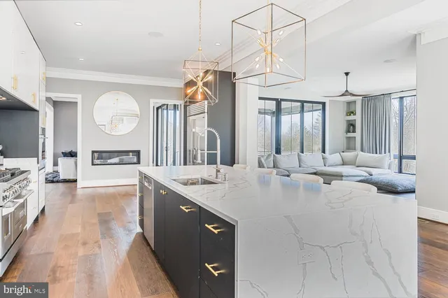 a kitchen with stainless steel appliances a sink stove and cabinets