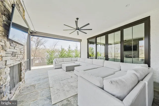 a living room with furniture a table and kitchen view