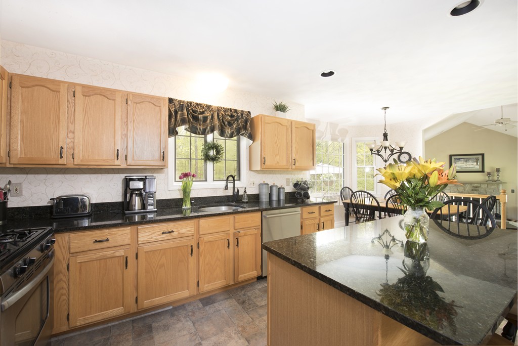 251 Ipswich Road Boxford, MA 01921 - Photo 5 of 27 a kitchen with granite countertop a sink and cabinets