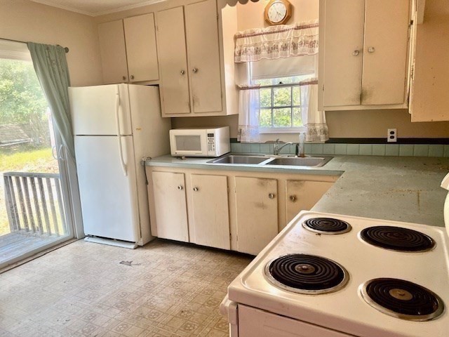 41 Woodland Road Chatham, MA 02659 - Photo 7 of 22 a kitchen with a refrigerator a stove a sink and a more cabinets