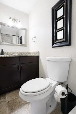a white toilet sitting next to a bath tub
