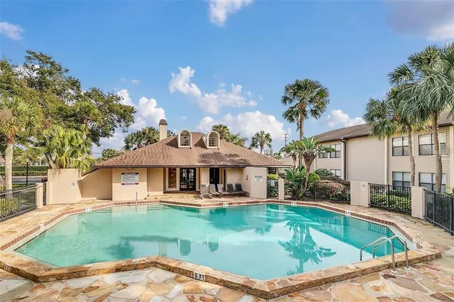 a view of a house with a swimming pool and a chairs