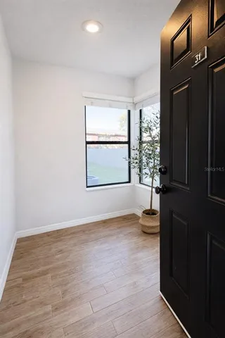 an empty room with windows and closet