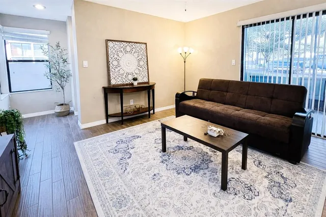 a living room with furniture and a painting on the wall