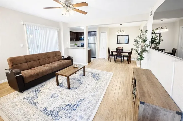 a living room with furniture and kitchen view