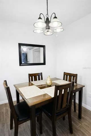a view of a dining room with a table and chairs