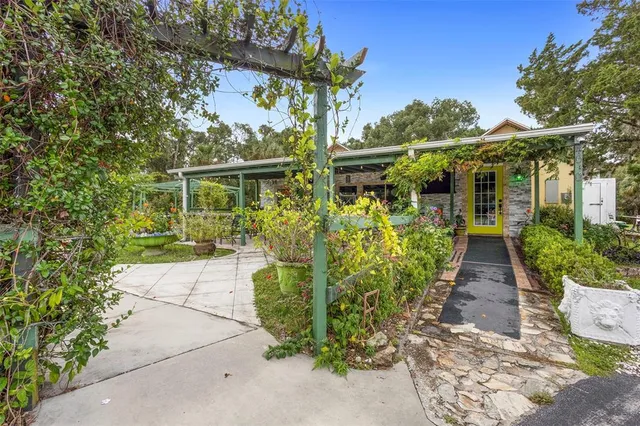 a backyard of a house with potted plants