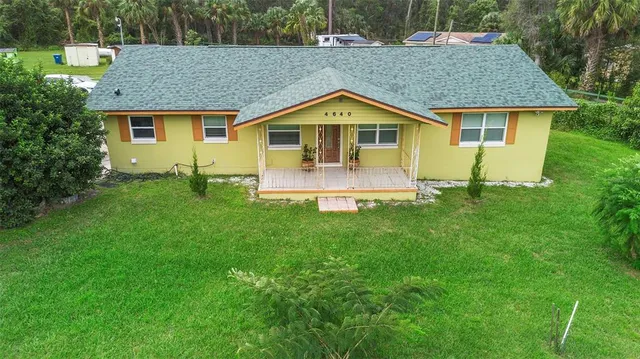 a kitchen with stainless steel appliances granite countertop a refrigerator and wooden floor
