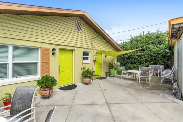 a outdoor dining space with furniture and wooden floor