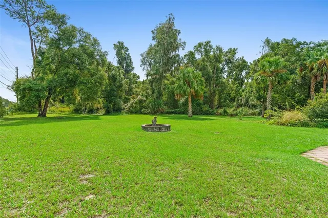 a living room with lots of furniture and kitchen view