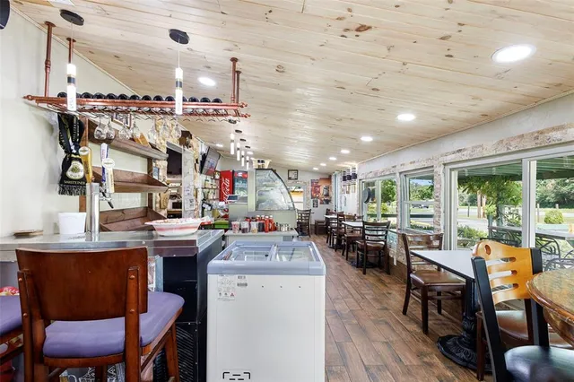 a living room with furniture wooden floor and a piano