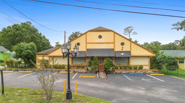 a view of a chair and table in backyard of the house