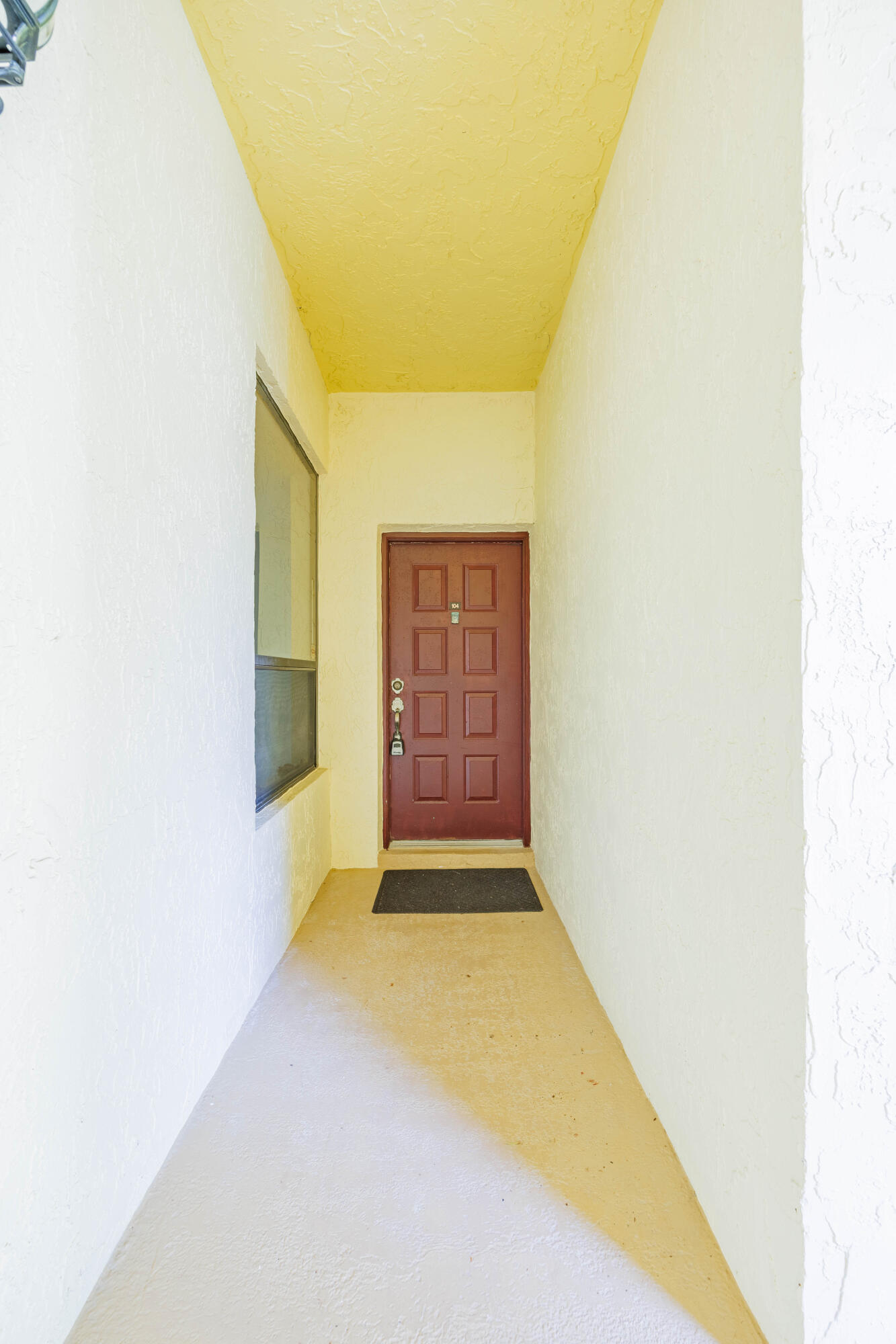 7520 La Paz Boulevard, Unit 104 Boca Raton, FL 33433 - Photo 10 of 56 a view of an empty room with a window