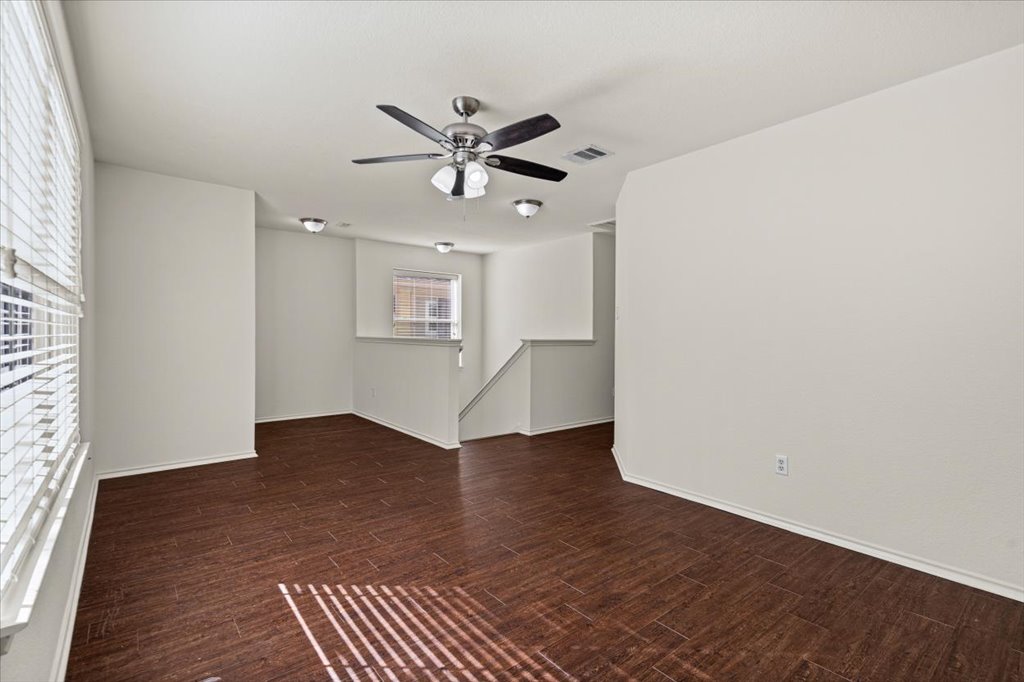 1316 Davis Mountain Loop Cedar Park, TX 78613 - Photo 11 of 24 an empty room with wooden floor fan and windows