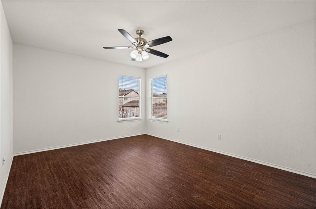 1316 Davis Mountain Loop Cedar Park, TX 78613 - Photo 13 of 24 a view of an empty room with wooden floor and a window