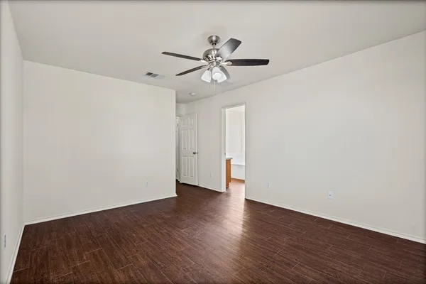 a view of a room with wooden floor and white walls