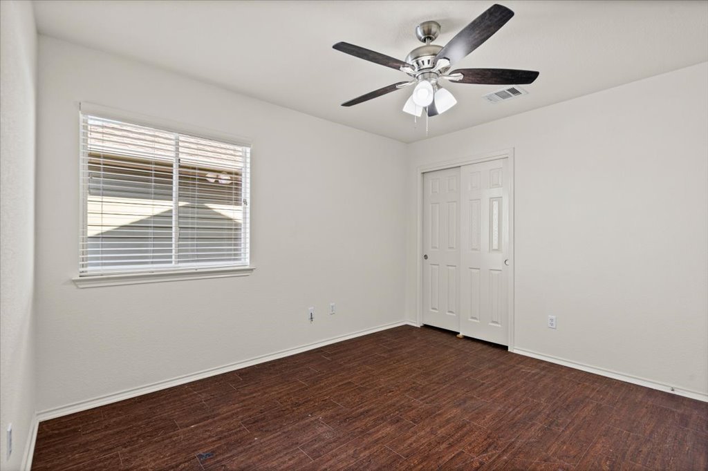 1316 Davis Mountain Loop Cedar Park, TX 78613 - Photo 18 of 24 a view of an empty room with window and wooden floor