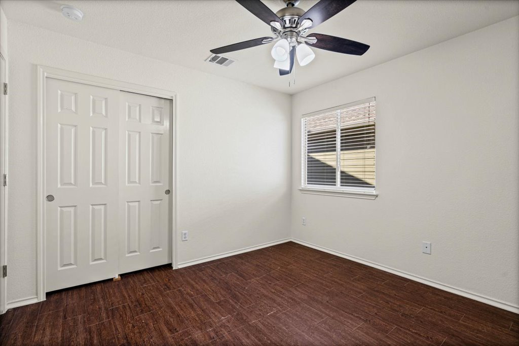 1316 Davis Mountain Loop Cedar Park, TX 78613 - Photo 20 of 24 a view of an empty room with wooden floor and a window