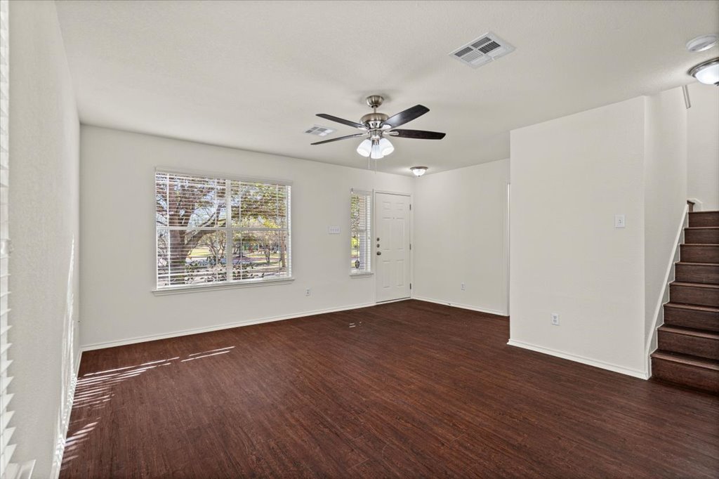 1316 Davis Mountain Loop Cedar Park, TX 78613 - Photo 2 of 24 an empty room with wooden floor and ceiling fan