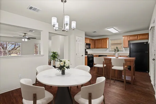 a view of a dining room with furniture wooden floor and a chandelier