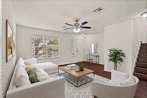 a living room with furniture and a potted plant