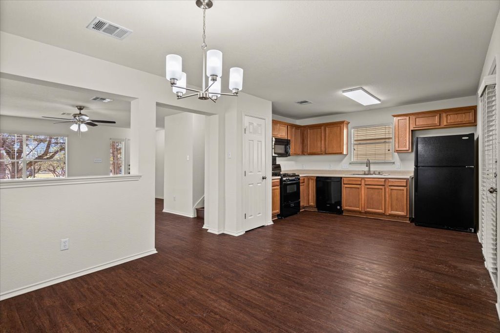 1316 Davis Mountain Loop Cedar Park, TX 78613 - Photo 4 of 24 a view of a kitchen with a sink stainless steel appliances and cabinets