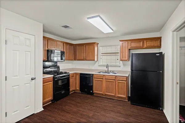 a kitchen with stainless steel appliances granite countertop a refrigerator stove and sink