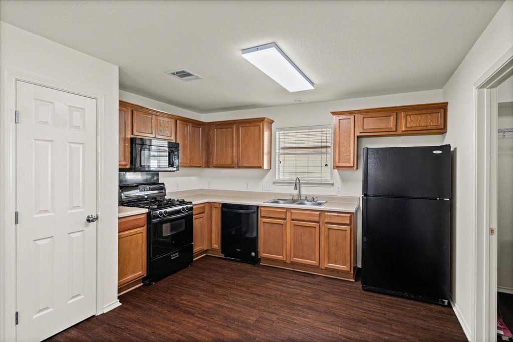 1316 Davis Mountain Loop Cedar Park, TX 78613 - Photo 6 of 24 a kitchen with stainless steel appliances granite countertop a refrigerator stove and sink