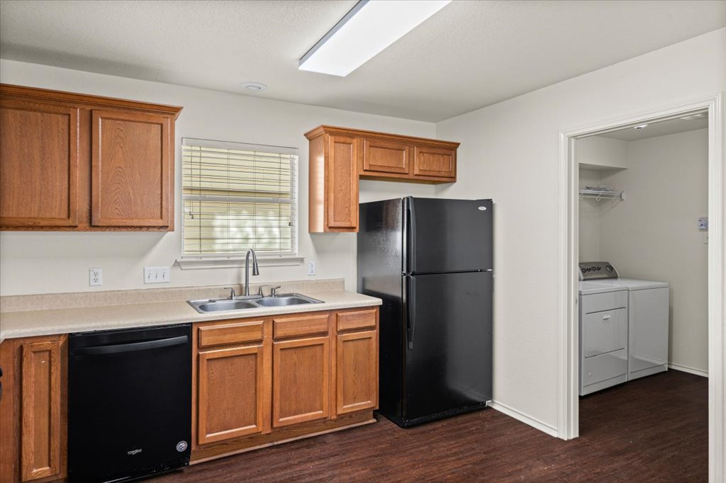 1316 Davis Mountain Loop Cedar Park, TX 78613 - Photo 7 of 24 a kitchen with a refrigerator sink and cabinets