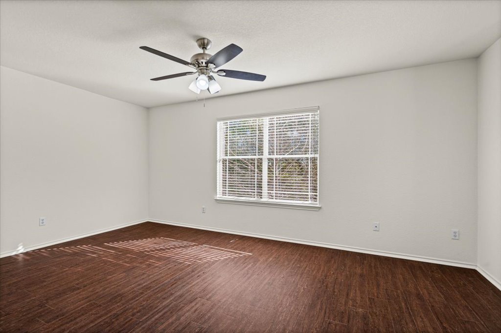 1316 Davis Mountain Loop Cedar Park, TX 78613 - Photo 10 of 24 a view of an empty room with wooden floor and a window