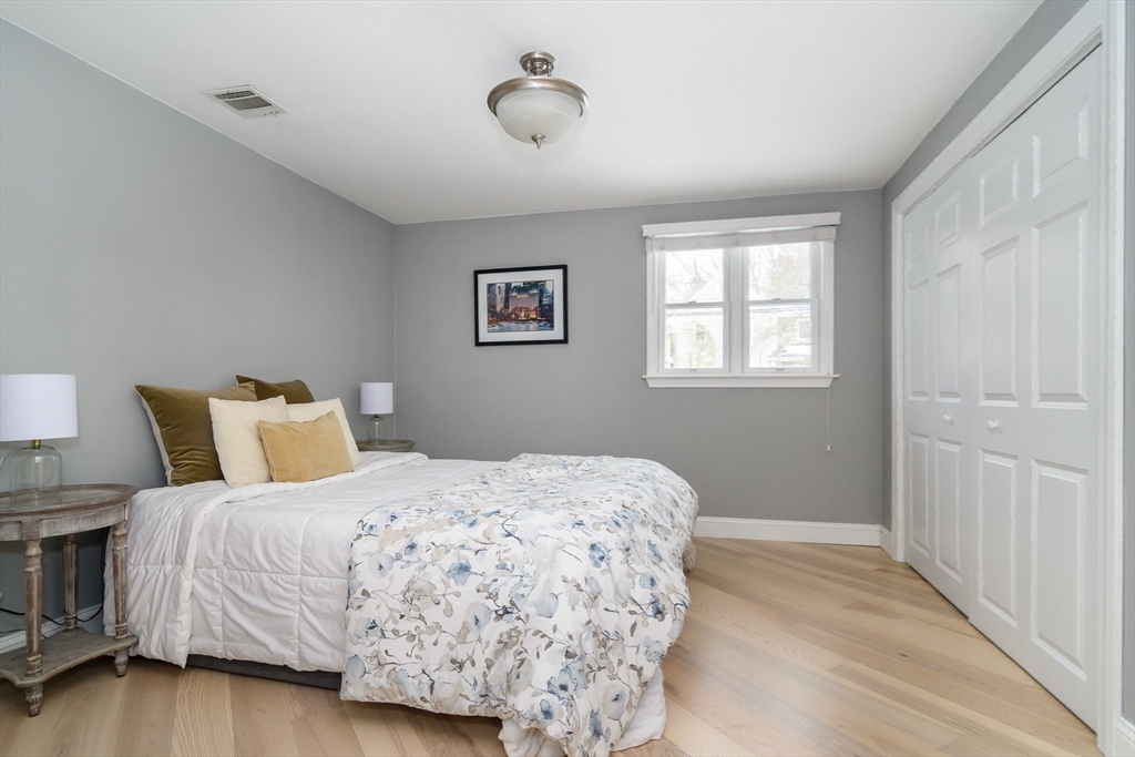 3 Oxbow Road Natick, MA 01760 - Photo 18 of 26 a bedroom with a bed and wooden floor