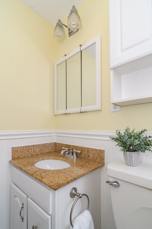 3 Oxbow Road Natick, MA 01760 - Photo 19 of 26 a bathroom with a granite countertop sink and a mirror