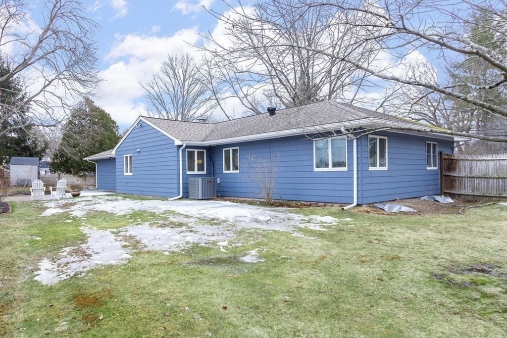 3 Oxbow Road Natick, MA 01760 - Photo 23 of 26 a backyard of a house with large trees and wooden fence