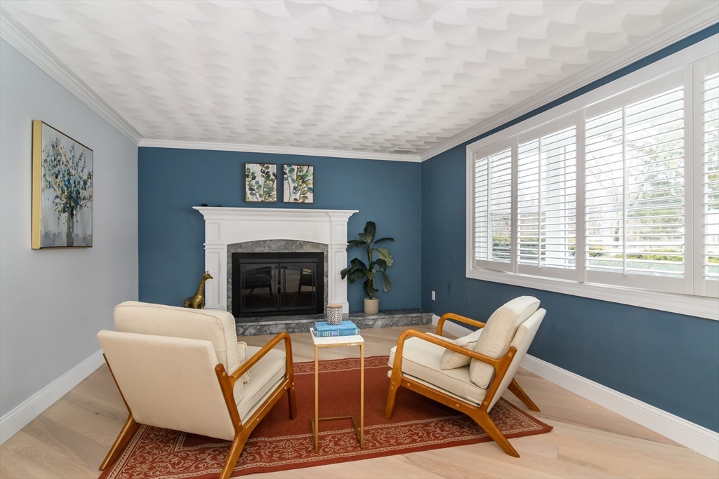 3 Oxbow Road Natick, MA 01760 - Photo 4 of 26 a living room with furniture a fireplace and a large window