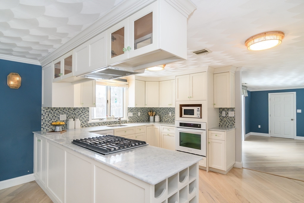 3 Oxbow Road Natick, MA 01760 - Photo 8 of 26 a kitchen with a stove a sink and a refrigerator