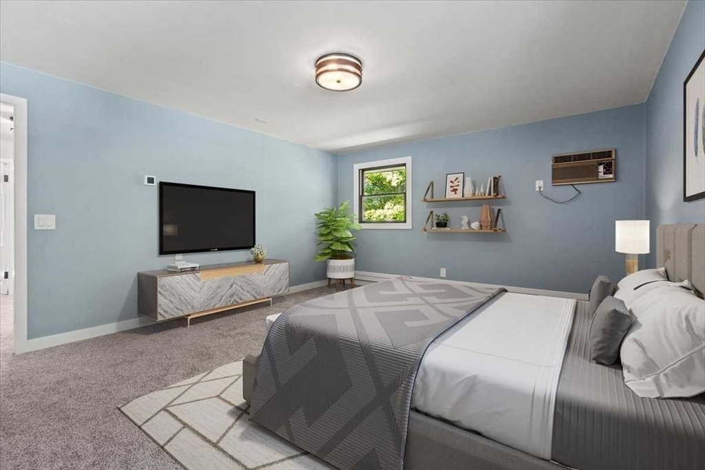 26 West Temple Street Boylston, MA 01505 - Photo 20 of 42 a bedroom with a bed and a flat screen tv
