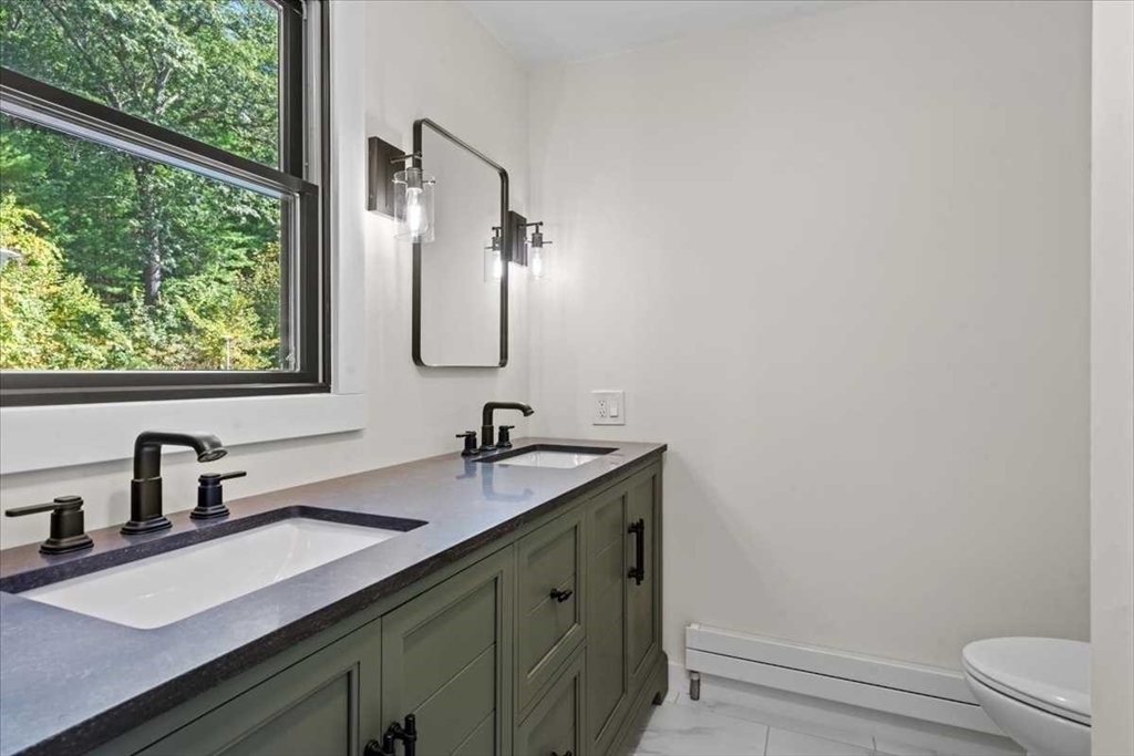 26 West Temple Street Boylston, MA 01505 - Photo 22 of 42 a bathroom with a sink and a mirror