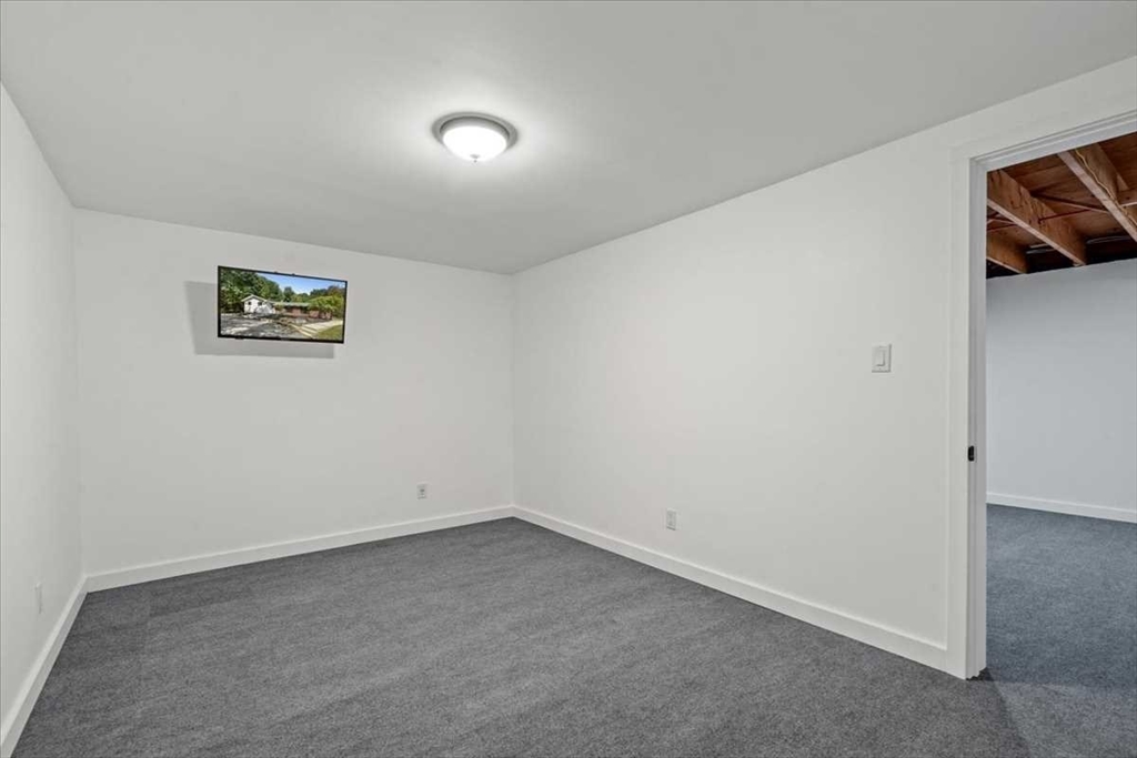 26 West Temple Street Boylston, MA 01505 - Photo 32 of 42 an empty room with a ceiling fan and window