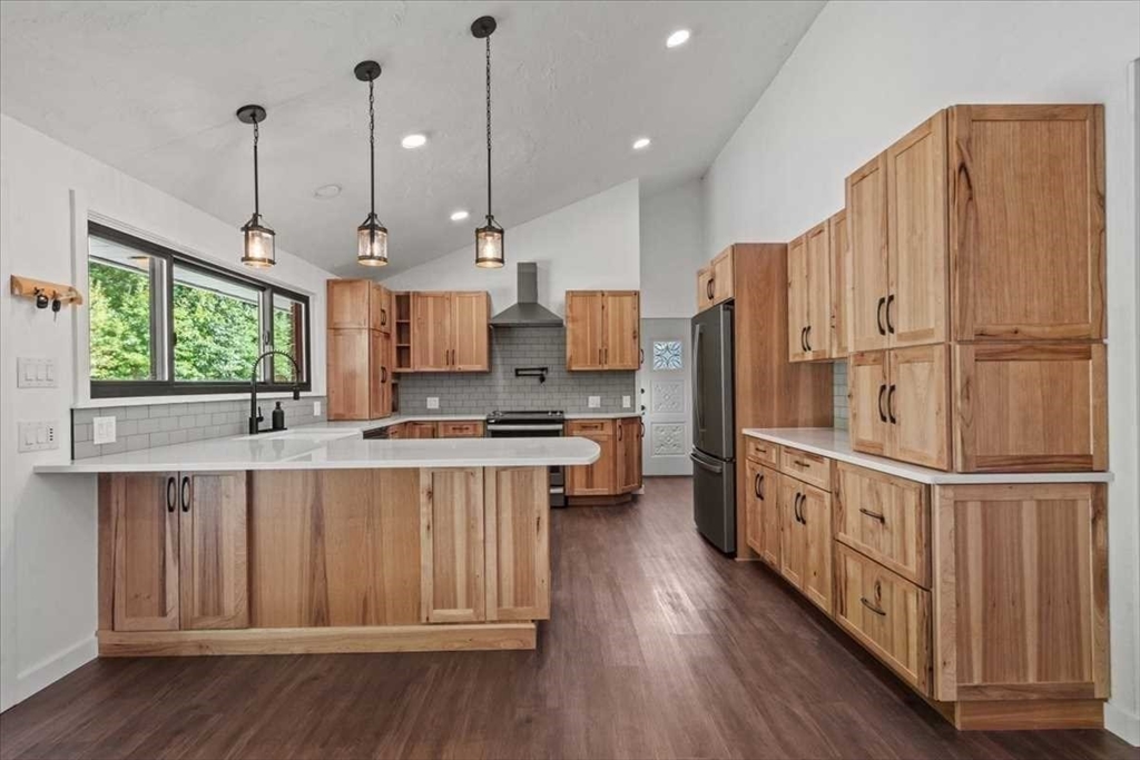 26 West Temple Street Boylston, MA 01505 - Photo 5 of 42 a large kitchen with stainless steel appliances granite countertop a stove a refrigerator a sink and a wooden floor