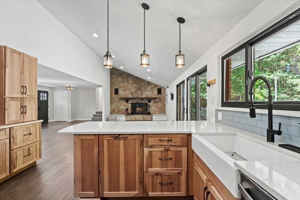 26 West Temple Street Boylston, MA 01505 - Photo 6 of 42 a view of a kitchen with a sink a large window stainless steel appliances and furniture