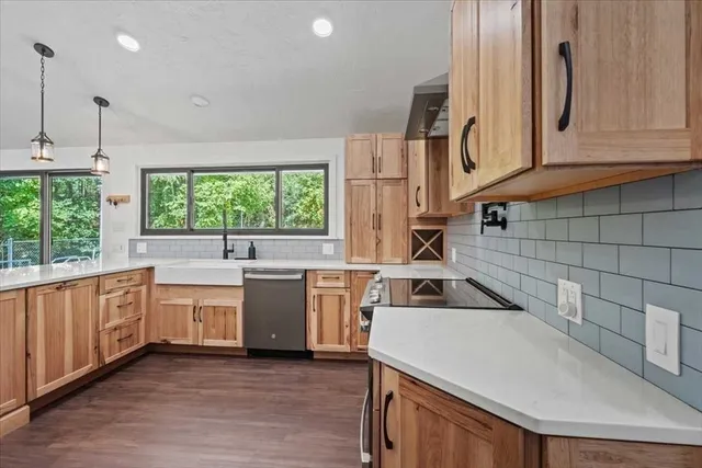 a kitchen with a sink a stove and cabinets