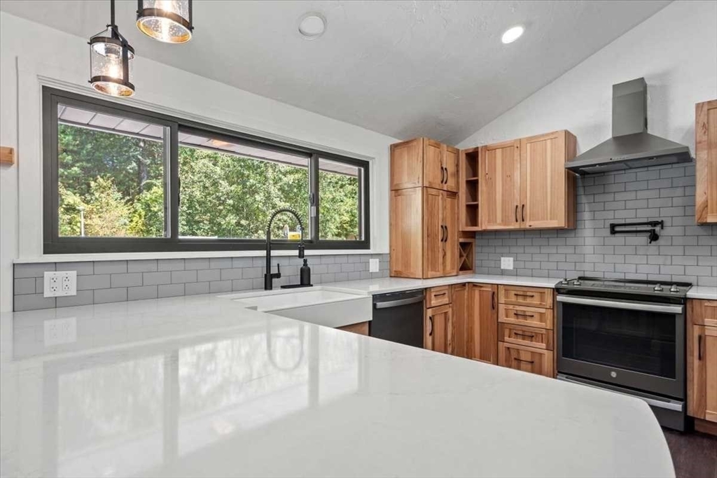 26 West Temple Street Boylston, MA 01505 - Photo 9 of 42 a kitchen with a stove a sink and a microwave